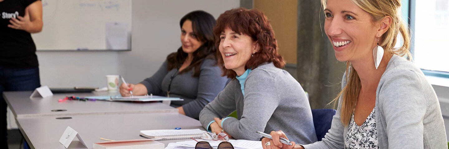Writing students listening on a workshop